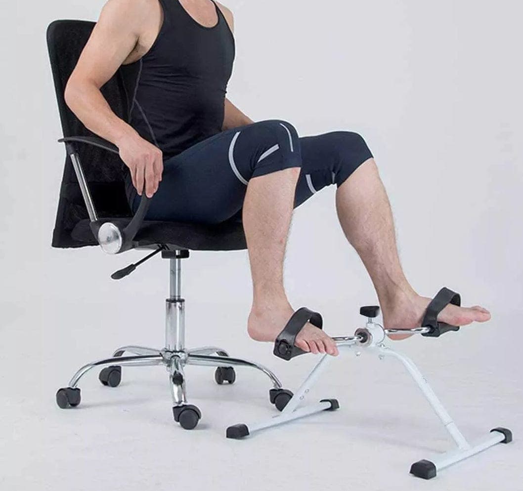 Man pedaling the arm pedal exerciser under an office chair